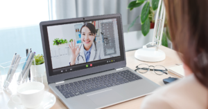 Doctor talking to patient during online meeting